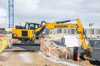 MX16G Lays Out Sand Along A Plinth Construction Site